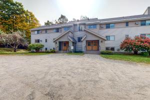 a large house with a dirt driveway in front of it at Smugglers' Notch Resort Slopeside 39 in Jeffersonville