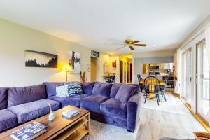 a living room with a purple couch and a table at Smugglers' Notch Resort Slopeside 39 in Jeffersonville