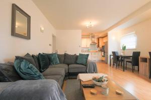a living room with a couch and a table at 2 bed spacious apartment in Cardiff CC in Cardiff