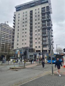 a tall building with people walking in front of it at 2 bed spacious apartment in Cardiff CC in Cardiff