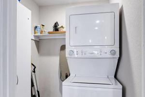 a white washer and dryer in a white laundry room at At Ease in San Antonio