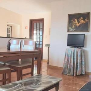 un soggiorno con scrivania e TV di Casa do Cruzeiro a Castanheiro