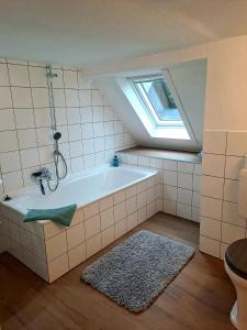 a bathroom with a bath tub with a window at Villa SKYLO in Winterberg