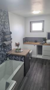 a kitchen with a desk and a sink in a room at Serviced Apartment - Aberdeen in Dyce