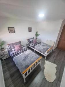 a room with two beds and a couch in it at Serviced Apartment - Aberdeen in Dyce