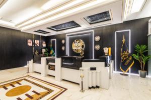 a room with black walls and gold accents at Ross Hotel in Riyadh