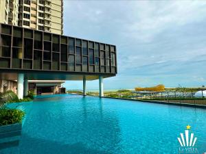 a large swimming pool in front of a building at Bali Residences Melaka by Lá VISTA in Melaka