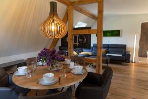 a dining room with a table and a living room at Spreewald Chalet Wohnung in Kolonie