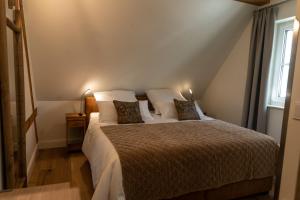 a bedroom with a large bed with two pillows at Spreewald Chalet Wohnung in Kolonie