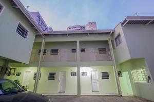 a white building with a balcony on the side of it at City Hotel, Curitiba in Curitiba +29 photos
