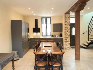 cocina y comedor con mesa de madera y sillas en Gîte Mareil-le-Guyon, 6 pièces, 12 personnes - FR-1-527-40, 