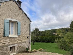 a stone house with a window and a yard at Maison de village charmante avec jardin et terrasse, proche de Soissons, idéale familles et animaux acceptés - FR-1-532-19 in Buzancy