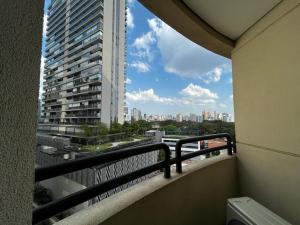 a balcony with a view of a tall building at Belíssimo FLAT - Faria Lima - Pinheiros in Sao Paulo