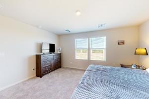 Dormitorio con cama y tocador con TV en Cottonwood Corner, en Benson