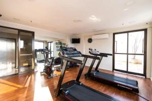 a gym with several tread machines in a room at Belíssimo FLAT - Faria Lima - Pinheiros in Sao Paulo