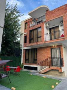 un edificio de ladrillo rojo con una mesa y un patio en villa with beautiful view 4, en Tiflis