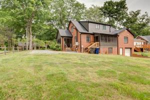 a house on a hill with a yard at Deacon Stays: The Polo - Walk to WFU in Winston-Salem