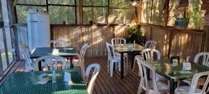 a patio with tables and chairs on a deck at Pousada Sol e Mar in Ilha do Mel