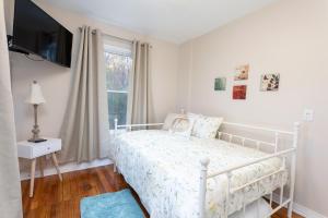 a white bedroom with a bed and a window at The Chattanooga Chill-Out in Ooltewah