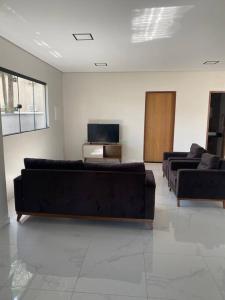 a living room with two couches and a television at CASA 11 - Condomínio Lençóis Park Barreirinhas in Barreirinhas