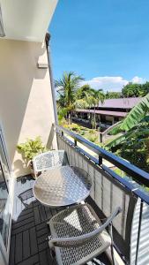 a balcony with a table and chairs on a building at CityCondo, 2nd Fl, 30 sqm, near CPU, balcony and parkview, Netflix, free parking in Iloilo City