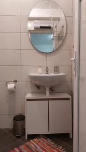 La salle de bains est pourvue d'un lavabo et d'un miroir. dans l'établissement Apartment Feral, à Neum