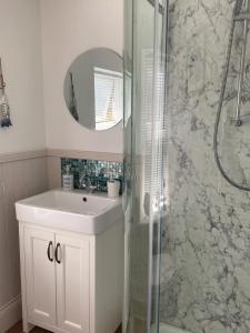a bathroom with a sink and a shower at Star Cottage - Harbottle - Nr Rothbury - Northumberland in Morpeth