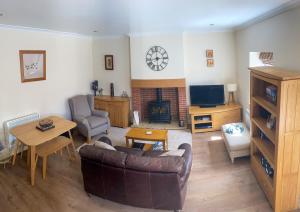 a living room with a couch and a fireplace at Star Cottage - Harbottle - Nr Rothbury - Northumberland in Morpeth