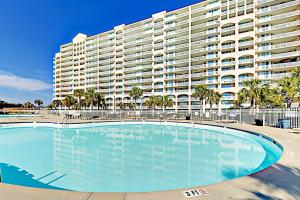 a swimming pool in front of a large building at Catalina Cove in North Myrtle Beach