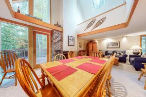 a dining room and living room with a table and chairs at Intervale 84 in Stratton Acres