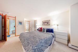 a bedroom with a bed and a dresser and a window at Intervale 84 in Stratton Acres