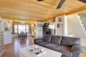 a living room with a couch and a table at Riverfront New Hampshire Cottage with Boat Dock in Manchester