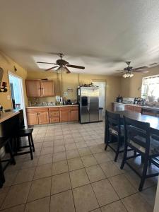 a kitchen with a ceiling fan and a table with chairs at WILLIAMS AZ HOSTEL in Williams