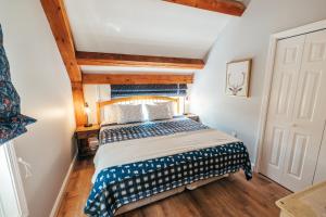 a bedroom with a bed in a room with wooden ceilings at Newly Renovated, Spacious Condo, 3 min to the ski lifts! in Bethel