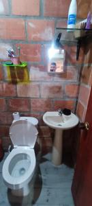 a bathroom with a toilet and a sink at Casa campó in Cali