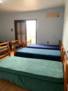 a bedroom with two beds and a chalkboard on the wall at Hostel 858 in Pelotas