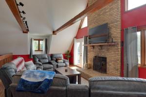 a living room with couches and a brick wall at Spacious McMinnville Vacation Home with Gas Grill! in McMinnville