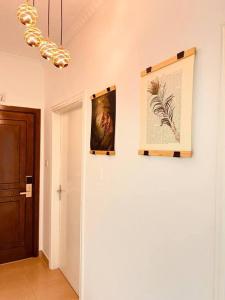 a hallway with two pictures on the wall and a chandelier at Lovely 3 bedrooms rental unit in Aqaba