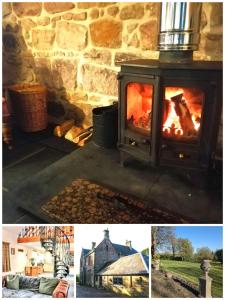 a stone fireplace with a fire in it at Stable Lodge in Berwick-Upon-Tweed