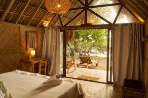 a bedroom with a bed in a room with a window at Hotel Isla Mucura in Isla Mucura