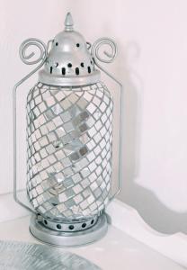 a glass jar with a silver top on a shelf at Zhantique Airport Guest House Unit 5 in Boksburg