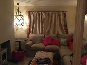 a living room with a couch and a window at St Anthony’s, bright perkily decorated 3 bedroom house in Ampleforth