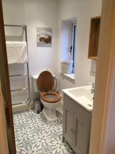 a bathroom with a toilet and a sink at St Anthony’s, bright perkily decorated 3 bedroom house in Ampleforth