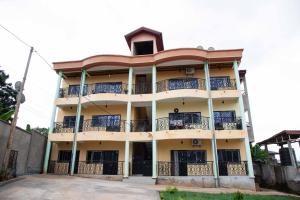 a building with balconies on the side of it at Hypo Guest Lounge in Yaoundé