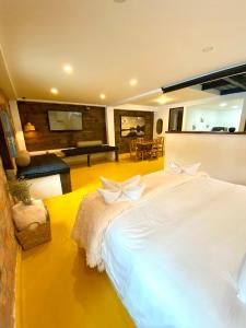 a bedroom with a large white bed with white bows at OPE Suites Usaquen in Bogotá
