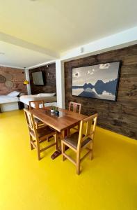 a dining room with a wooden table and chairs at OPE Suites Usaquen in Bogotá