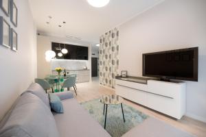 a living room with a couch and a tv at HomeStay 3 with private parking in Toruń