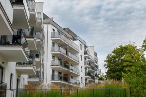 an apartment building with balconies on the side of it at HomeStay 3 with private parking in Toruń