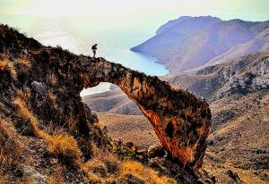 a person standing on the edge of a mountain at Ecoturismo Cabo Tiñoso in Murcia