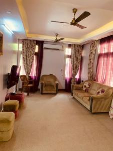 a living room with a couch and a tv at Jamesville-4BHK Villa, Wi-Fi, SmartTV - CityCentre in Bangalore